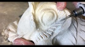 Crafting an owl sculpture out of birch wood