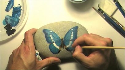 How to paint a butterfly on a sea rock